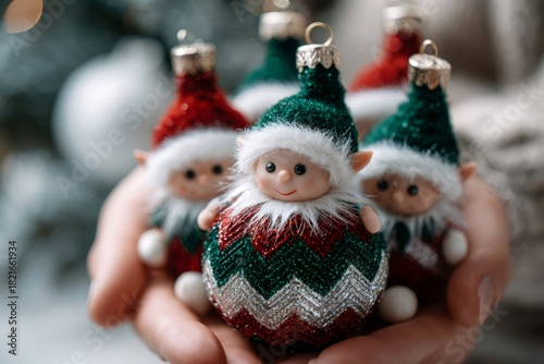 Hands holding cute christmas elf ornaments for holiday decoration