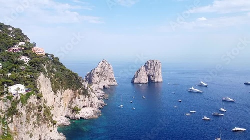 Aerial view of Faraglioni rocks and boats in Capri, Italy