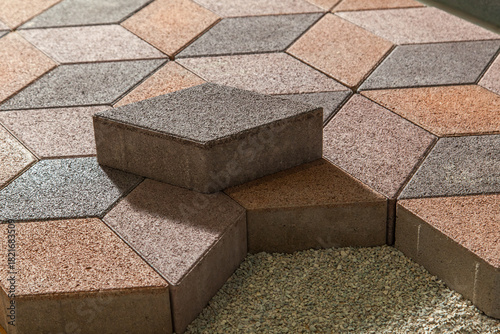 Building an pedestrian path with paver bricks. Sidewalk pavement. Process of laying interlocking concrete paving stones on a gravel base