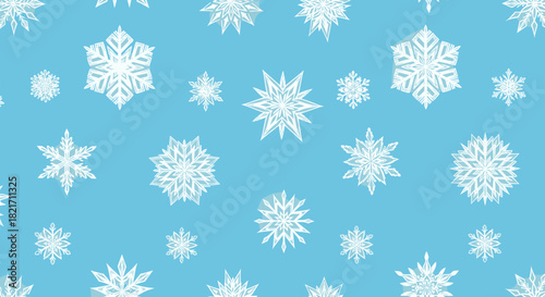 Arrangement of snowflakes of varying sizes on a light blue colored plane