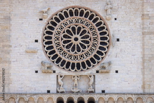 Decorative facade with rose window of romanesque 12th century Assisi Cathedral, Assisi, Italy