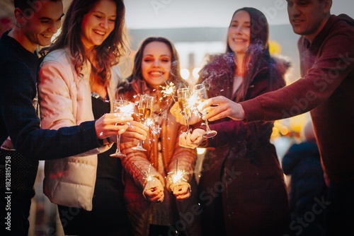 Group funny people winter holidays. Christmas concept with firework sparkler