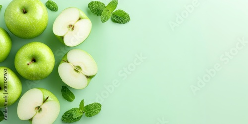 Wallpaper Mural A Fresh Arrangement of Green Apples and Mint Leaves on a Pale Green Background, Highlighting the Natural Beauty of Healthy Fruits Torontodigital.ca