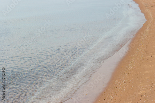 Billede på lærred The calm waters of Lake Michigan slowly wash on shore, casually wiping away the