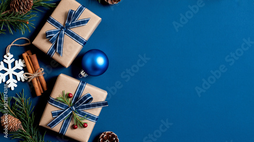 Festive christmas gifts and decorations arranged on a deep blue background