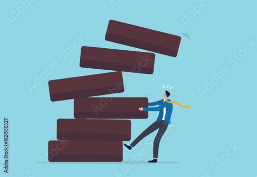 Investment risk, failure or mistake for greedy decision, business strategy to be careful and balance on instability and uncertainty concept, businessman pulling wooden block from collapsing stack.