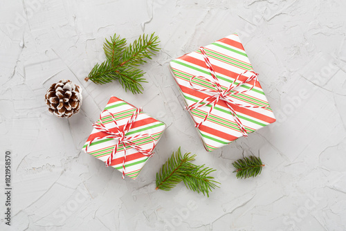 Striped Christmas gift boxes on concrete background, top view