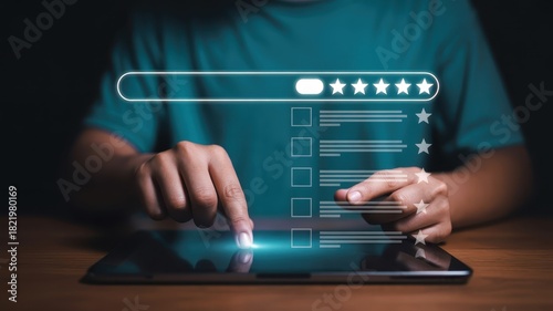 Person interacts with digital interface displaying a five-star rating system on a handheld device