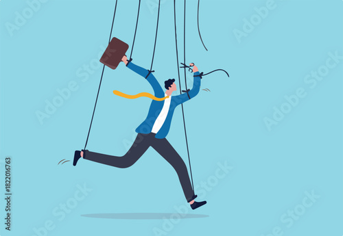 Freedom for work and decision making, authority to work independently, stop micromanagement, or people manipulation concept, businessman marionette, puppeteer use scissors to cut controlled strings. 