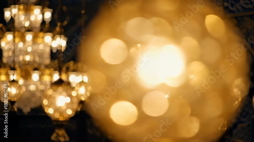 Intricate Islamic decor with illuminated chandeliers and arabesque wall patterns create a warm