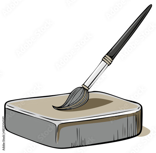 Artist's brush dips into watercolor paint stone for creative artwork