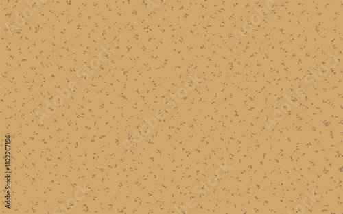 A tan surface with small dark specks evenly distributed across the entire visible area of the image