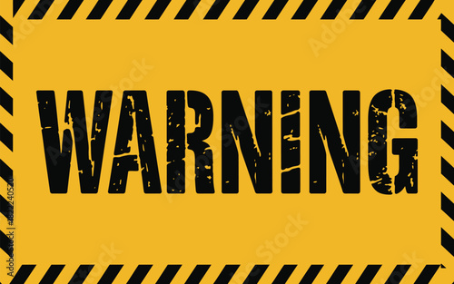 A yellow warning sign with black diagonal stripes and the word warning in distressed black letters