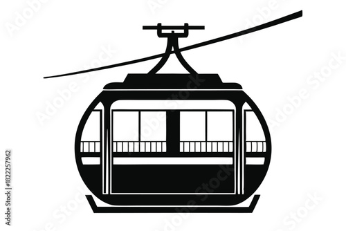 A simple black and white gondola ascends the cable in stark isolation