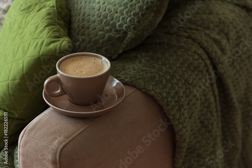 Cup of Hot Coffee Stay on Arm of Cozy Couch by Blanket