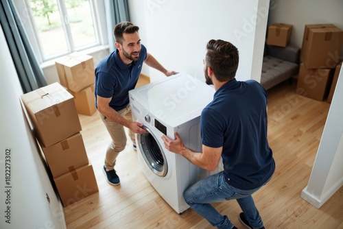 Delivery Team Carefully Bringing New Washing Machine to Home with Moving Boxes and Furniture in Background