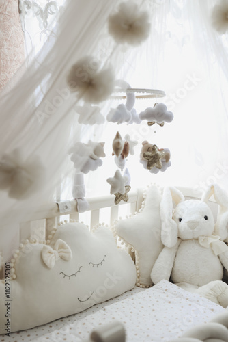 nursery mobile with soft felt clouds and stars above a baby crib. Concept: cozy, safe newborn space. Ideal for baby-product brands, handmade sellers, nursery decor ads, blogs, and online stores. 