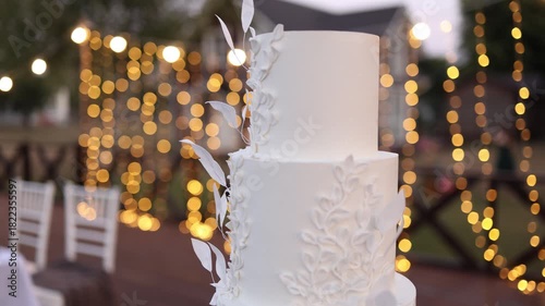 White wedding cake on a white table
