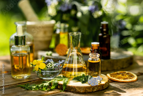 Alternative green herbal medicine. Natural plant-based ingredients for skin care beauty products, perfumery production. Small business, laboratory, drug research, organic extracts in glassware