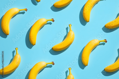 A bunch of bananas are arranged in a pattern on a blue background