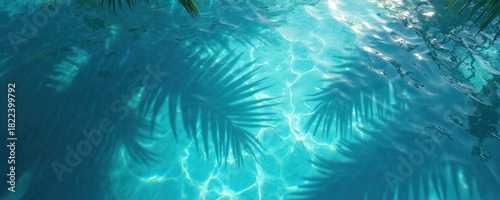 Clear blue water surface with rippling texture and dark palm leaf shadows. Sunlight creates bright patterns and reflections on aquatic background. Calm and serene natural scene.