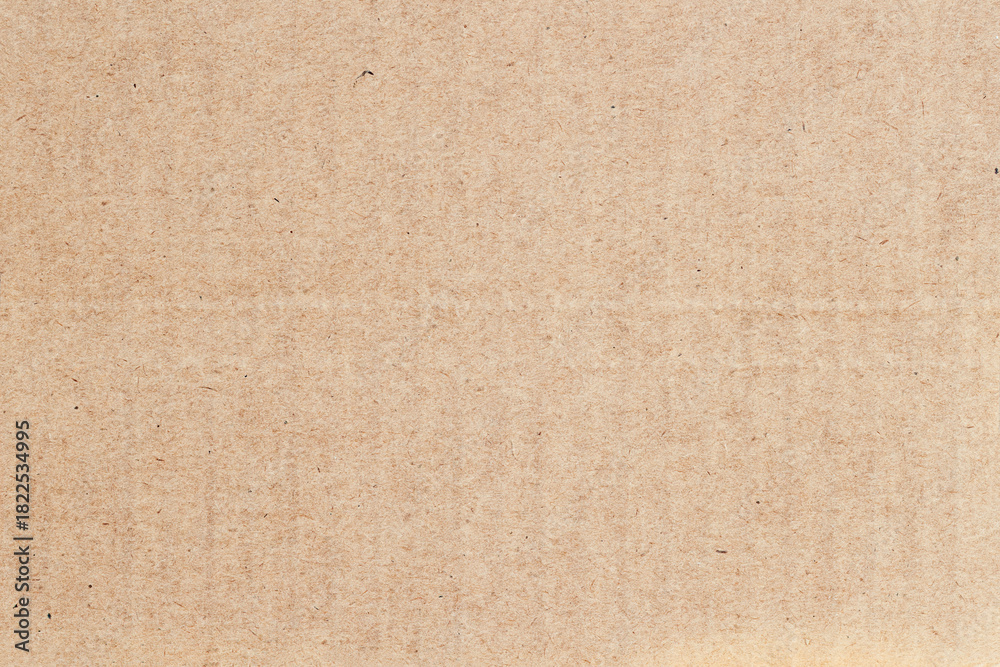 Fototapeta premium Flat recycled cardboard texture with visible natural fibers and neutral color tone. Natural background for eco-friendly design, copy space