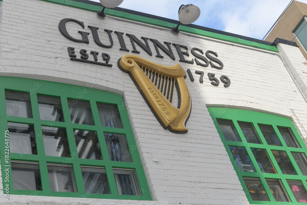 Fototapeta premium exterior wall with Guinness logo sign at The Coffee Bar @ The Harp located at 174 Eglinton Av E, Toronto