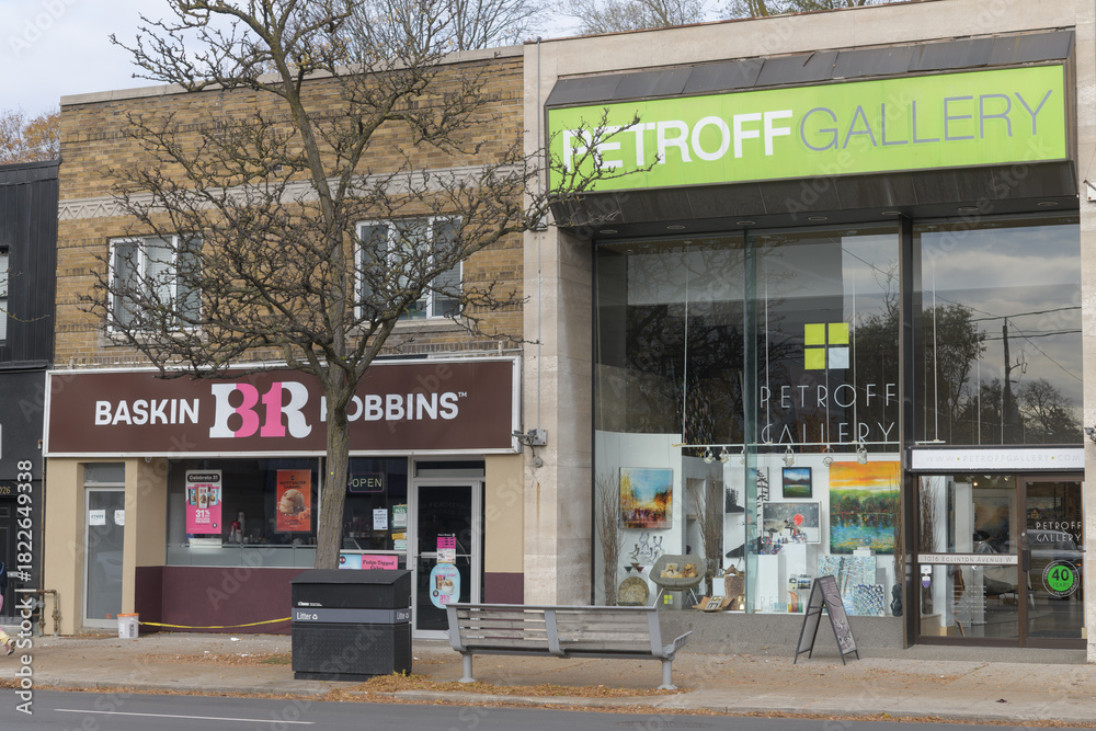 Fototapeta premium facade and signs of Baskin-Robbins and Petroff Gallery on Eglinton Av W, Toronto