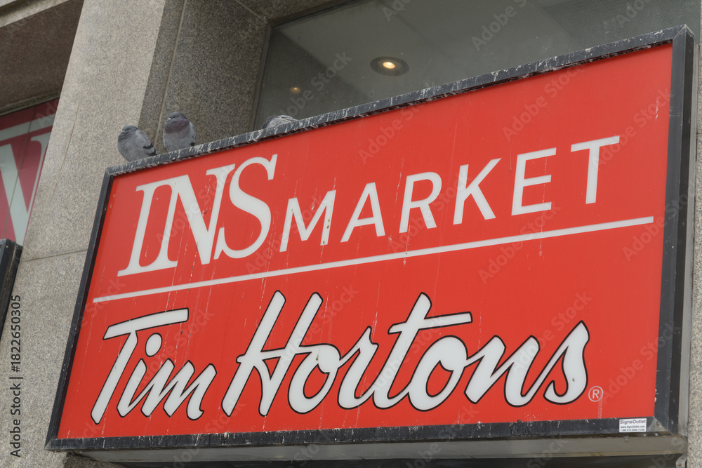Fototapeta premium sign above entrance to INS Market & Tim Hortons Express located at 50 Eglinton Av E, Toronto