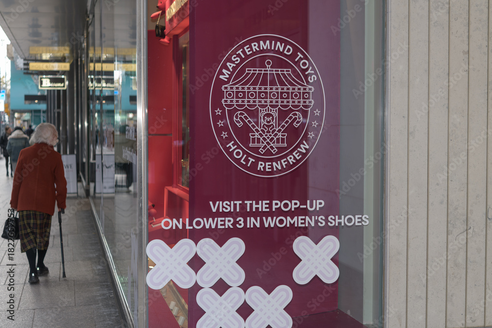 Fototapeta premium Mastermind Toys pop-up shop at Holt Renfrew sign and shop windows (looking west on Bloor W) located at Holt Renfrew Centre located at Bloor St W, Toronto