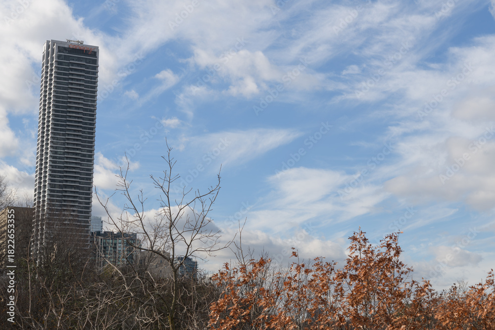 Naklejka premium wide view of Canopy by Hilton Toronto Yorkville with blue sky and clouds 387 Bloor St E