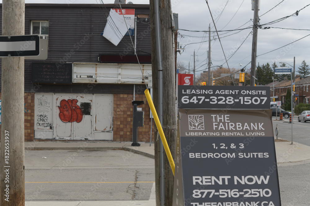 Fototapeta premium sidewalk sign near The Fairbank, an apartment complex, located at 9 Croham Rd, Toronto (photo: looking east on Eglinton Av W)