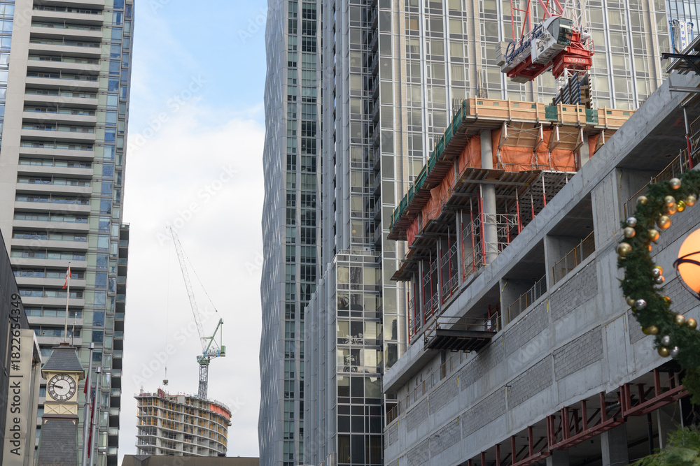 Obraz premium looking east on Yorkville Av to new construction site and clock tower at fire station 312, Toronto