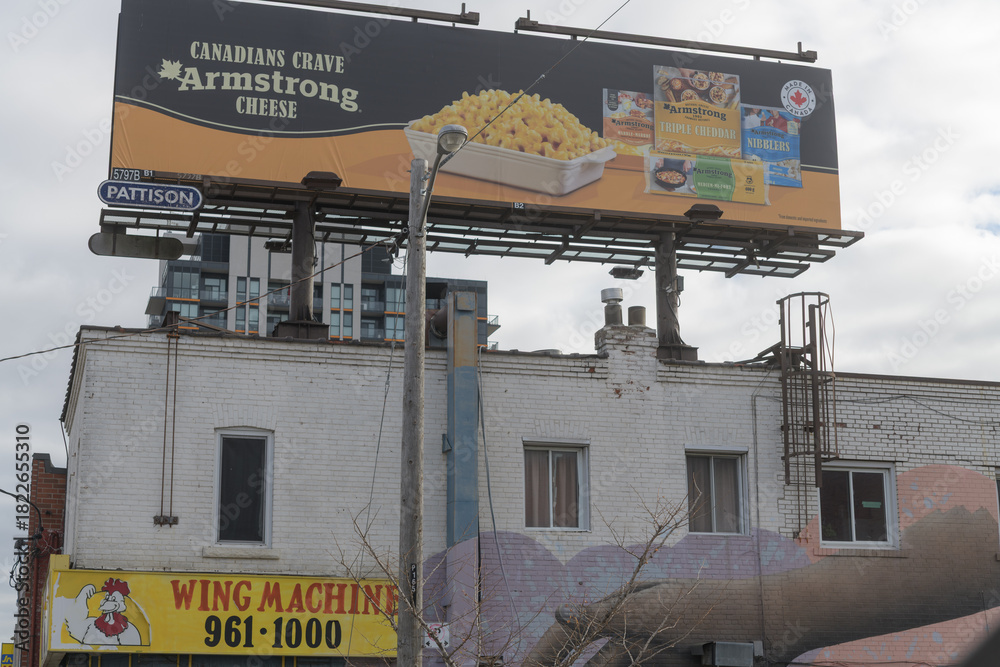 Fototapeta premium rooftop billboard for Armstrong cheese above Wing Machine located at 1661 Eglinton Av W, Toronto