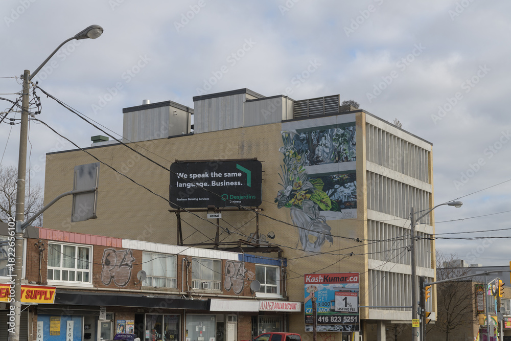 Obraz premium wide view of a rooftop billboard for Desjardin Financial on Eglinton Av W (Ajmer Dollar Discount), Toronto