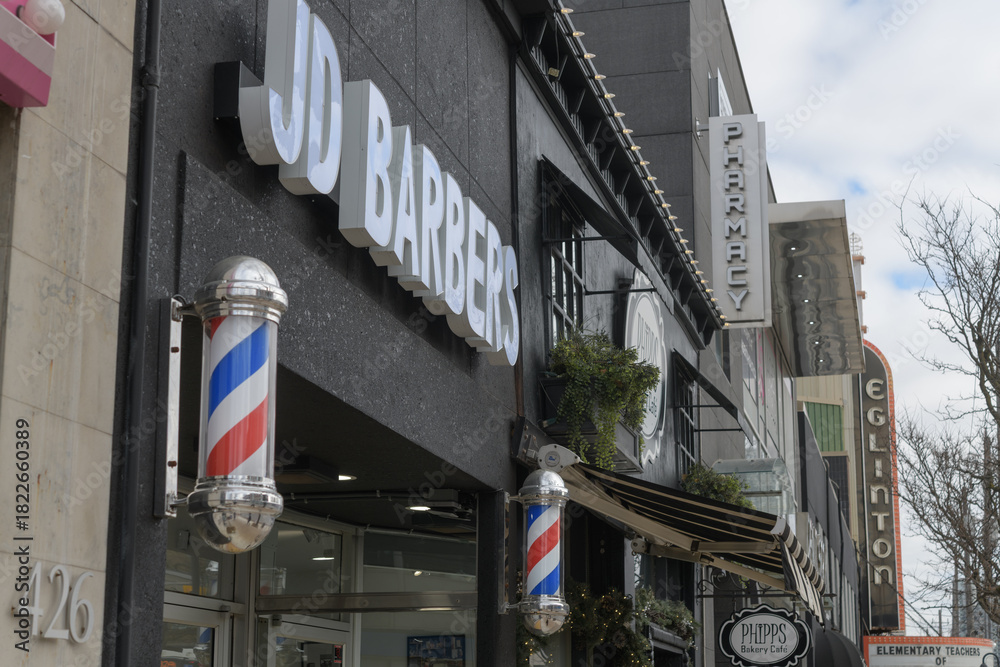 Obraz premium signs of Eglinton Av W, incl JD Barbers at 424 Eglinton Av W, Toronto