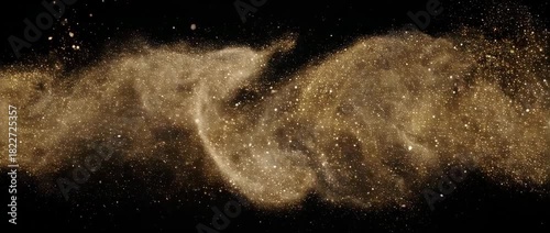 A luxurious and elegant stream of golden particles flowing like liquid dust against a black background.