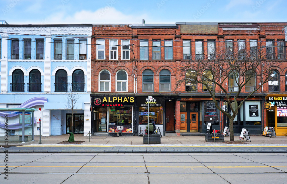 Fototapeta premium Old buildings with stores and restaurants in the trendy west end of downtown Toronto
