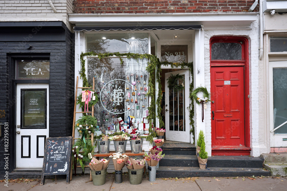 Fototapeta premium Old buildings with stores and restaurants in the trendy west Queen Street area of Toronto