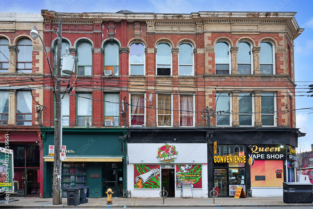 Obraz premium Old buildings with stores and restaurants in the trendy west Queen Street area of Toronto