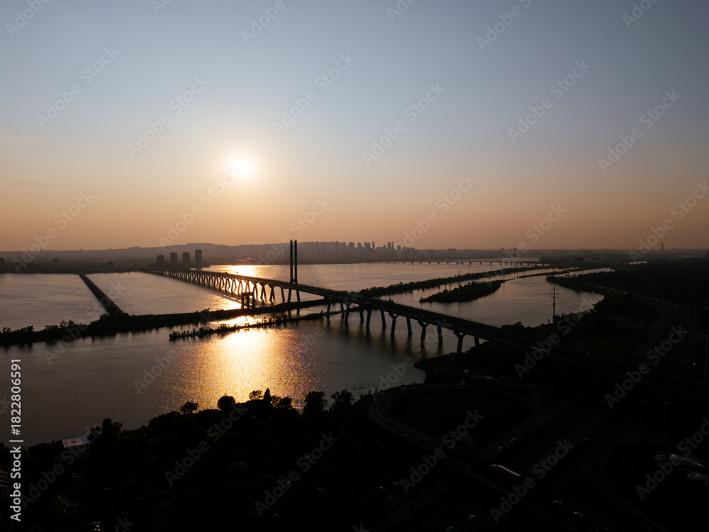 Fototapeta premium Cable stayed bridge over St Lawrence River at golden sunrise near Montreal and Brossard, Canada. g.