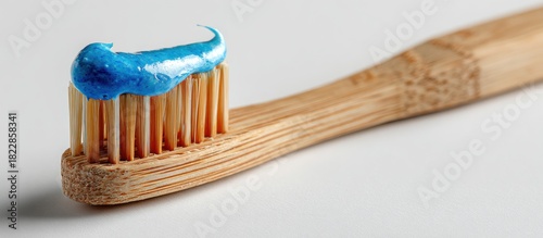 A close-up shot shows a wooden toothbrush with blue toothpaste applied