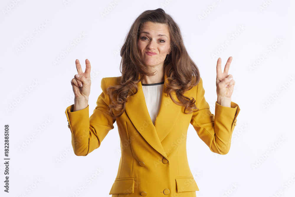 Obraz premium A businesswoman with wavy hair, wearing yellow blazer, exudes insecurity and makes finger-quote gesture. She gestures with fingers, making quotation marks, indicating that everything is really bad