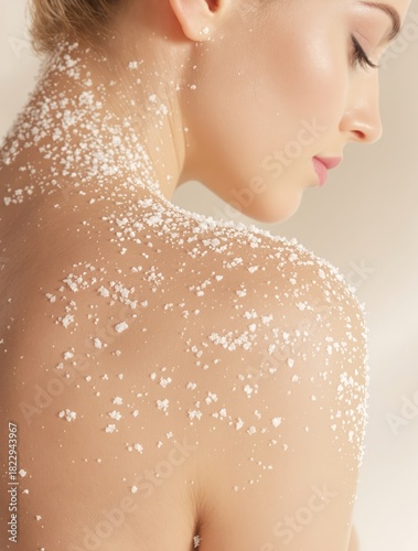 Exfoliation body treatment with scrub on woman's shoulder