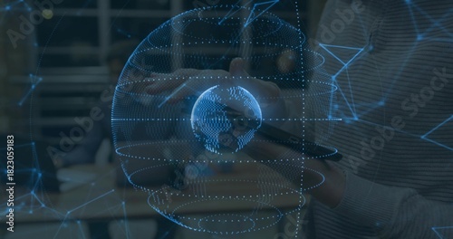 Projecting holographic globe aligning with hands and tablet in office, with staff in ribbed sweater