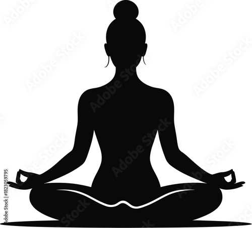 Silhouette of a woman meditating in lotus pose yoga
