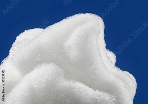 Airy, white soapy foam pile and bubbles isolated against a bright background. Macro shot showing the delicate texture of the suds and cleaning bubbles ,light ,detergent ,abstract