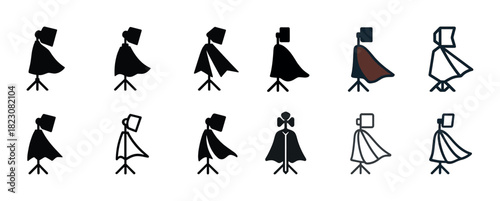 Windswept figures in silhouette and color capes on tripod stands