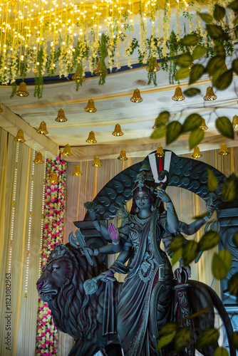 A beautifully crafted idol of Goddess Durga with multiple arms holding various weapons, seated on a majestic lion