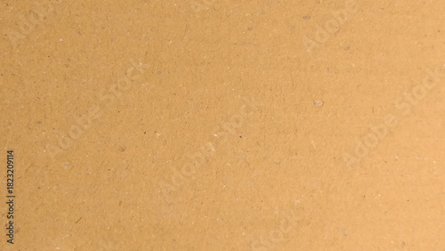 Brown paper texture background for presentation product. Pastel peach illumination, grainy color gradient background.